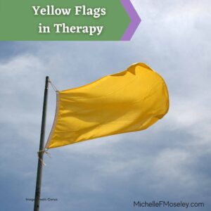 a yellow flag waves in the wind with a blue sky background