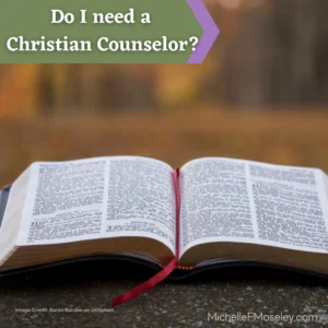 An open Bible with a red ribbon bookmark laid between the pages.  