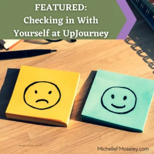 Two stacks of sticky notes sit side-by-side on a wooden desk.  One is yellow with a sad face drawn in black marker, the other is blue with a happy face drawn in black marker.