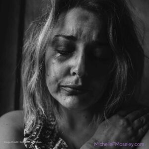 Woman is crying and appears distraught after experiencing religious trauma and spiritual abuse.