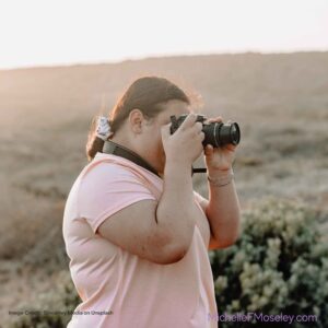Person showing passion for taking pictures and not worried about body image concerns.