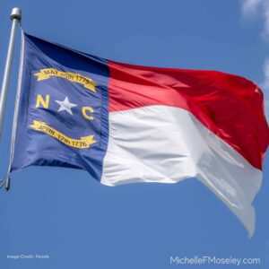 North Carolina state flag waving in the wind to represent the counseling services I provide in NC.