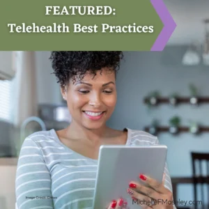A woman with light brown skin, short, curly black hair and wearing a light gray shirt is holding a tablet and meeting with her therapist via telehealth.  