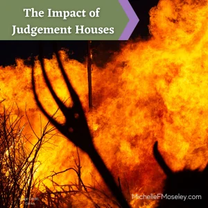 Silhouette of a pitchfork and Devil horn in front of orange flames.  