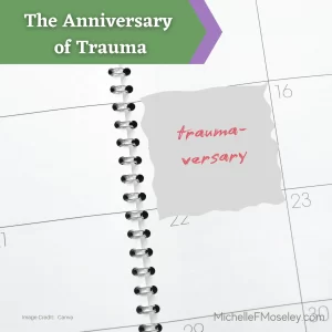 Image of a white calendar page in a spiral notebook with squares outlined in black and numbers representing the date.  A square near the center of the image reads "trauma-versary" in red letters.