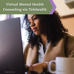 A Black woman with curly, shoulder length hair is looking at her laptop screen as she engages in virtual therapy via telehealth.