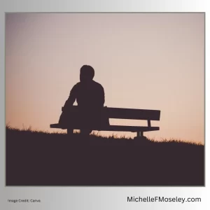 Silhouette of person sitting alone on a bench showing the loneliness of religious trauma experiences.