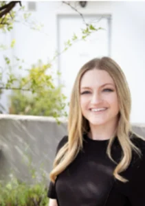 Dr. Jessica Hogan, a white woman with long blonde hair wearing a black shirt.
